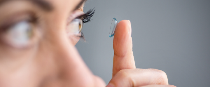 Woman applying a contact lens