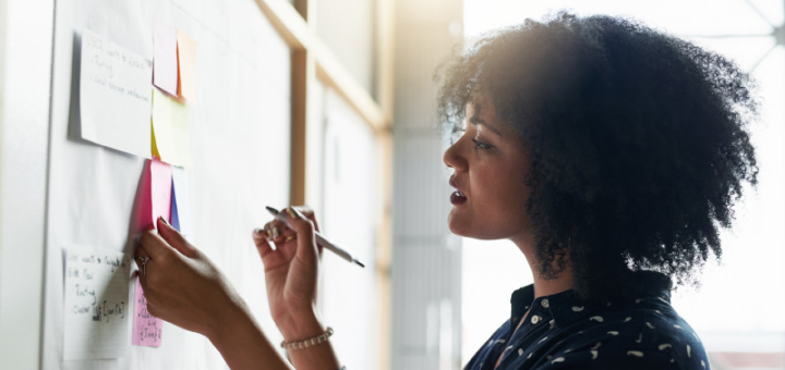 Woman writing on board