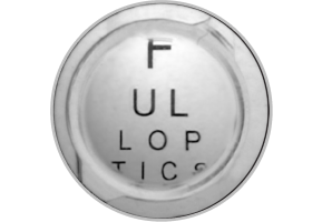 Close-up image of a TECNIS 1-Piece IOL with letters behind it, showing the use of the limited 4.9 mm aspheric optic.