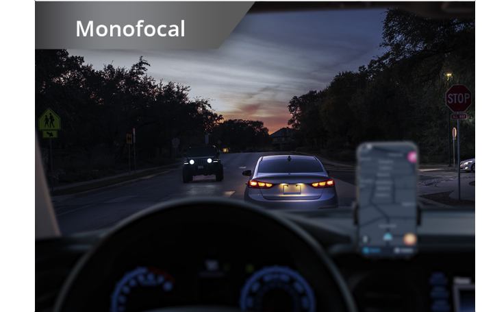 Car on the road in dim lighting with phone set up on the dashboard. White text at the top left corner of this image reads “Monofocal.”