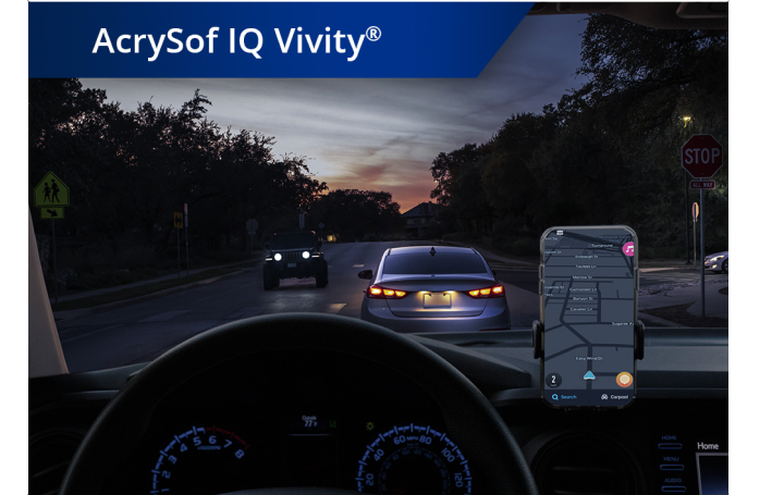 Car on the road in dim lighting with phone set up on the dashboard. White text at the top left corner of this image reads “AcrySof IQ Vivity.”