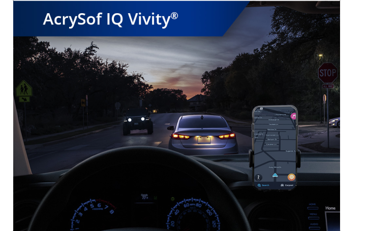 Car on the road in dim lighting with phone set up on the dashboard. White text at the top left corner of this image reads “AcrySof IQ Vivity.”