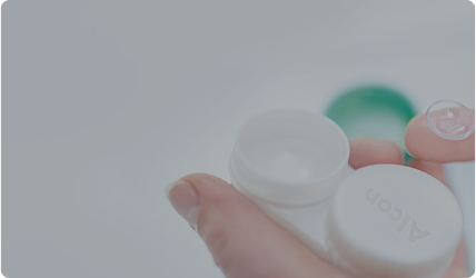 Image of lens on finger and packaging for contact lenses