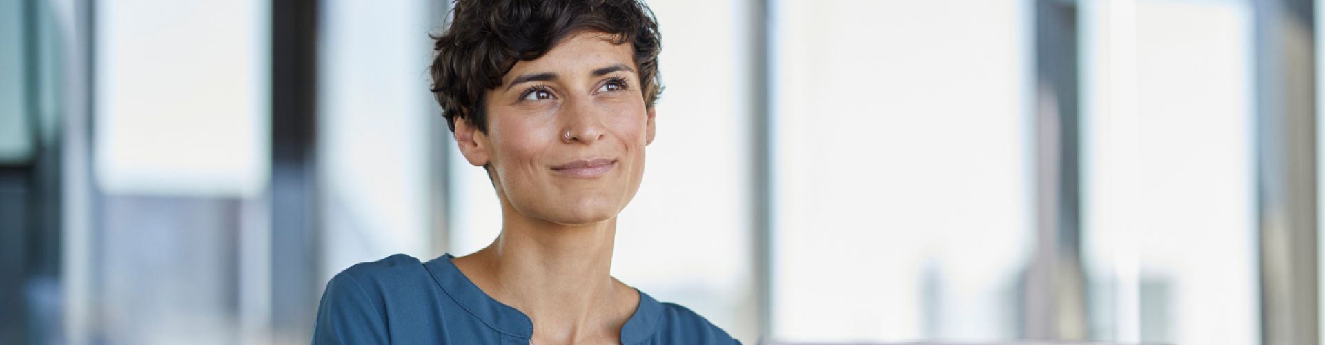 Smiling woman with a laptop in the office