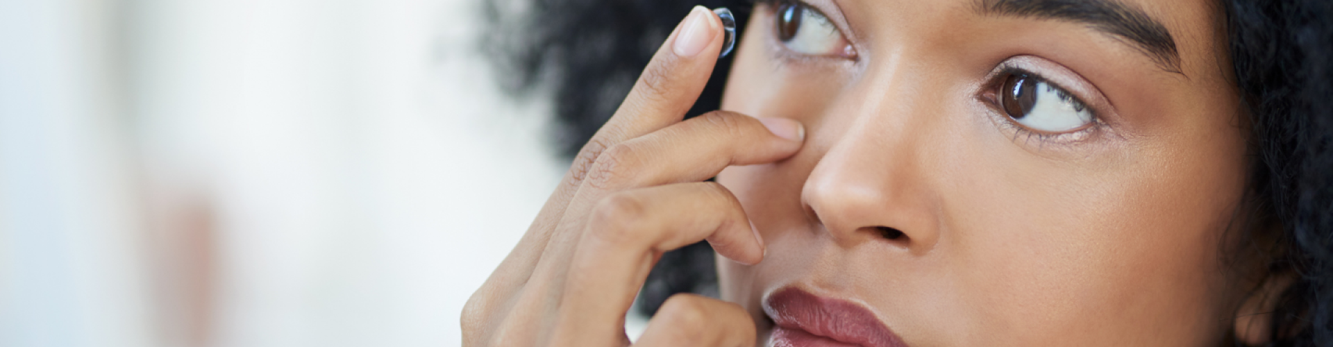 Woman applying a contact lens