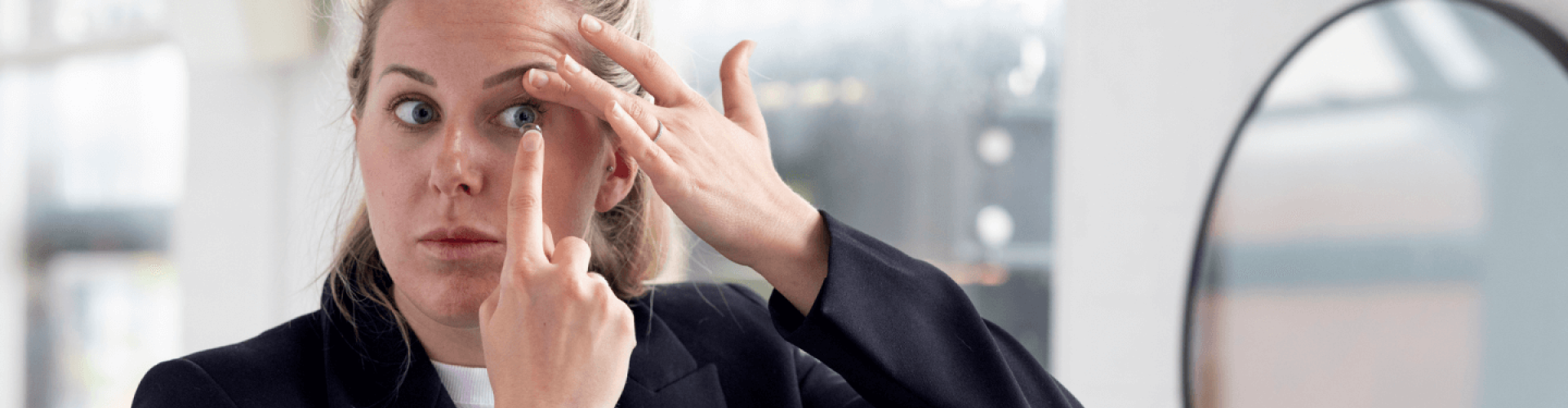 Woman putting in a contact lens