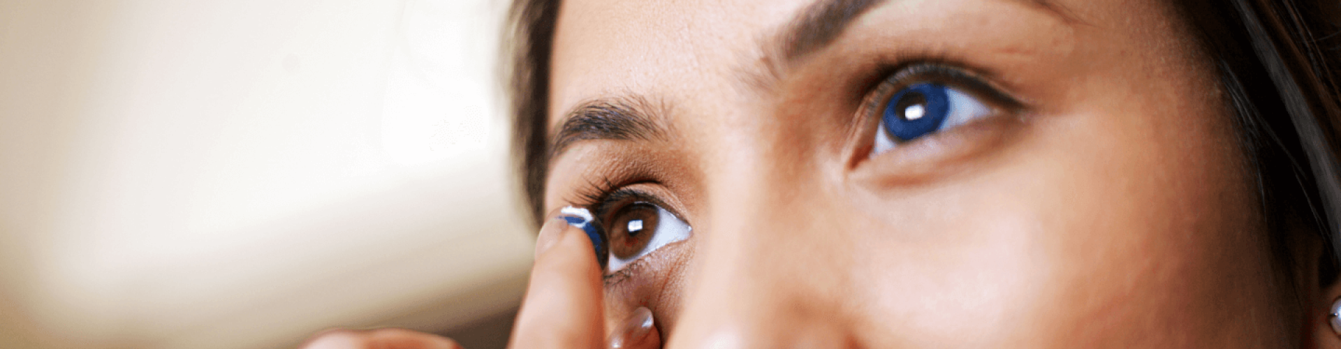 Woman inserting a contact lens