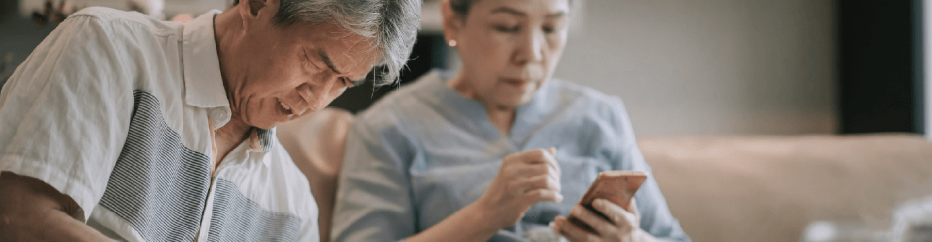Elderly couple looking for information on their phone