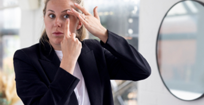 Woman putting in a contact lens