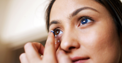 Woman inserting a contact lens