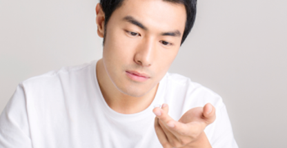 Man with contact lens on finger