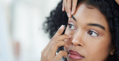 Woman applying a contact lens
