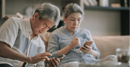 Elderly couple looking for information on their phone