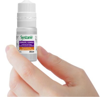 Image of a hand with a bottle of Systane Complete PF