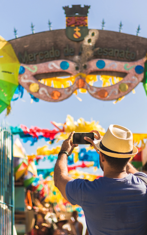 Person taking a photo at an amusement park