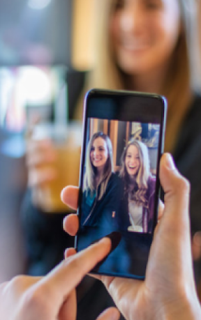 Woman taking photo with friends
