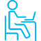 Icon of a person at a desk with a laptop