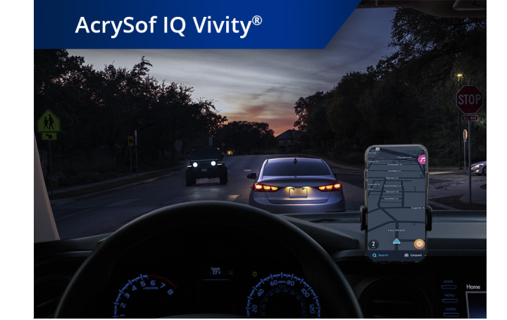 Car on the road in dim lighting with phone set up on the dashboard. White text at the top left corner of this image reads “AcrySof IQ Vivity.”