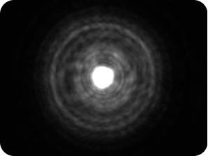 Black background with a bright light in the middle, with a halo around the light larger than the Clareon Monofocal and Clareon Vivity IOLs, representing the optical bench halo measurement for TECNIS Symfony Diffractive IOL.