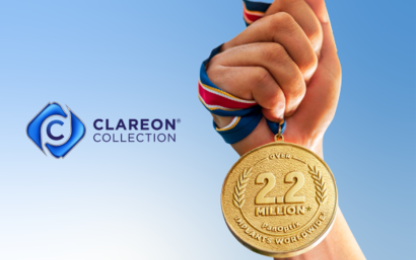 Image of a hand holding a gold medal