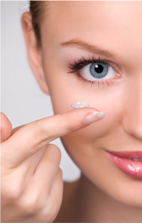 Close-up of a woman holding a contact lens on her finger