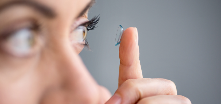 Woman applying a contact lens