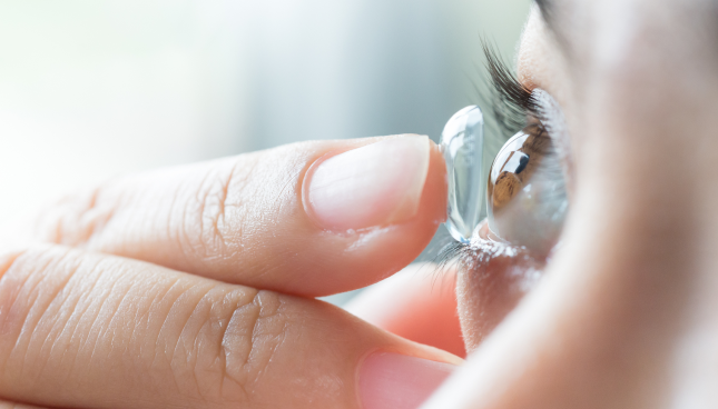 Woman wears contact lens