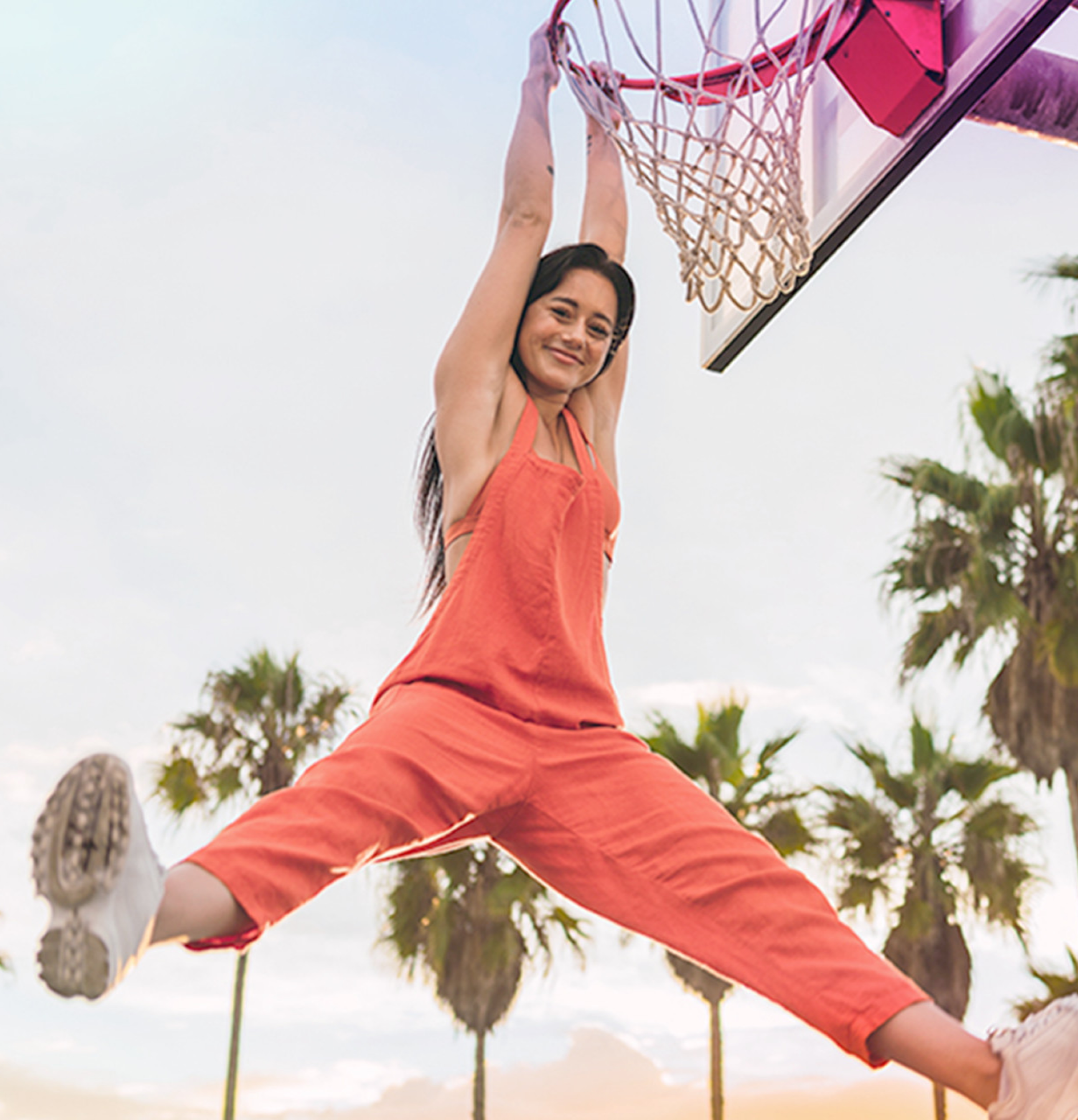 Girl playing basketball in overalls