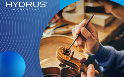 Image of a person repairing an instrument and hydrus logo