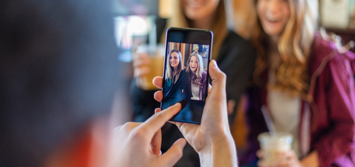 Woman taking photo with friends