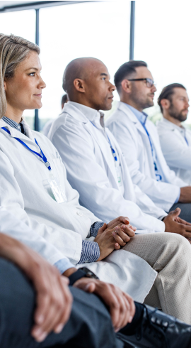 People in white shirts listening to the lecture