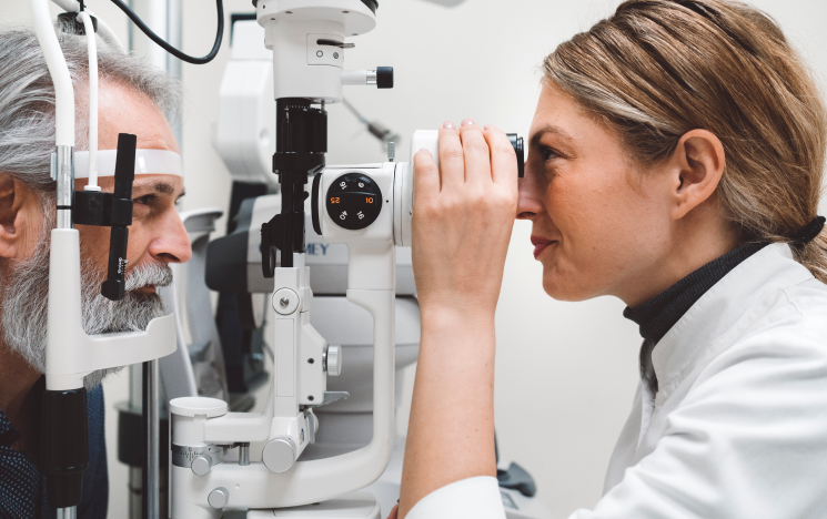 Opthamologist checking patient's eyes