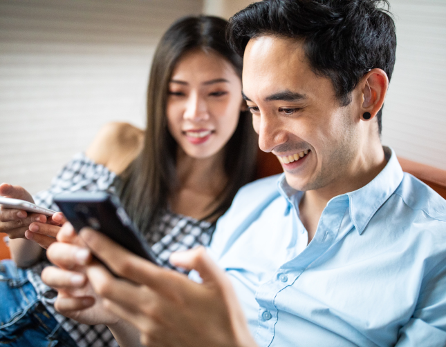 Couple on sofa with phones