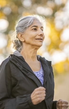 Older woman running outside