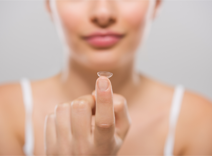 Woman applying contact lenses
