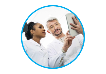 An image of man and woman wearing lab coats. The man is showing the woman something on a tablet.