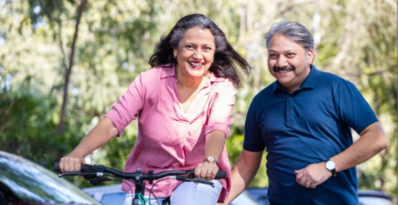 A woman on a bicycle and a man next to her