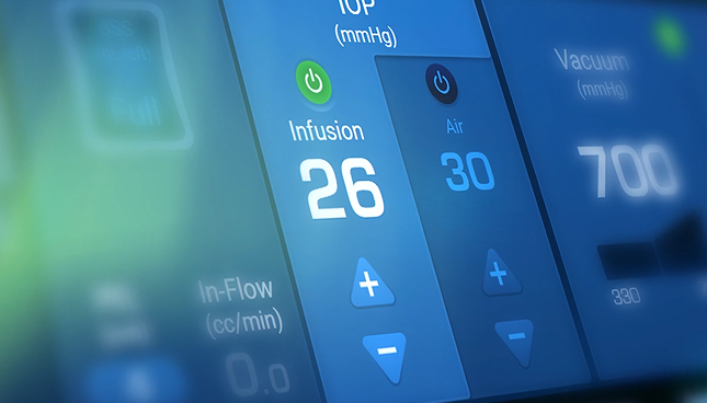 Close-up of a surgical system touchscreen showing infusion at 26 mmHg, air at 30, and vacuum at 700 mmHg with control buttons