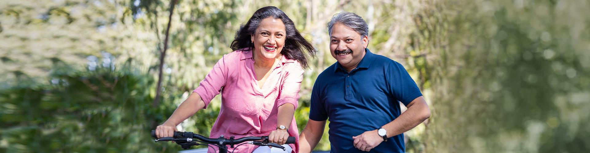 A woman on a bicycle and a man next to her