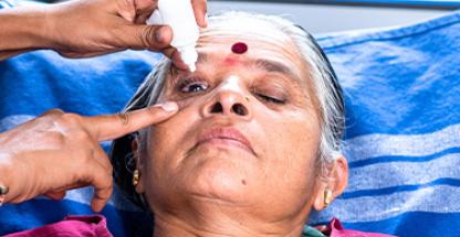 Elderly person during eye drops