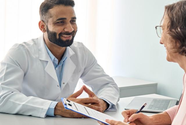 A doctor talking to an elderly person
