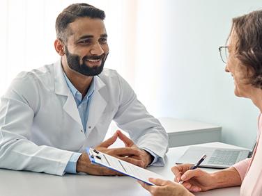 A doctor talking to an elderly person