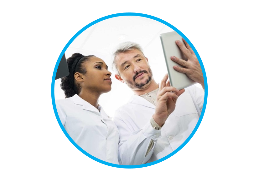 An image a man and a woman wearing a lab coat while interacting with a tablet