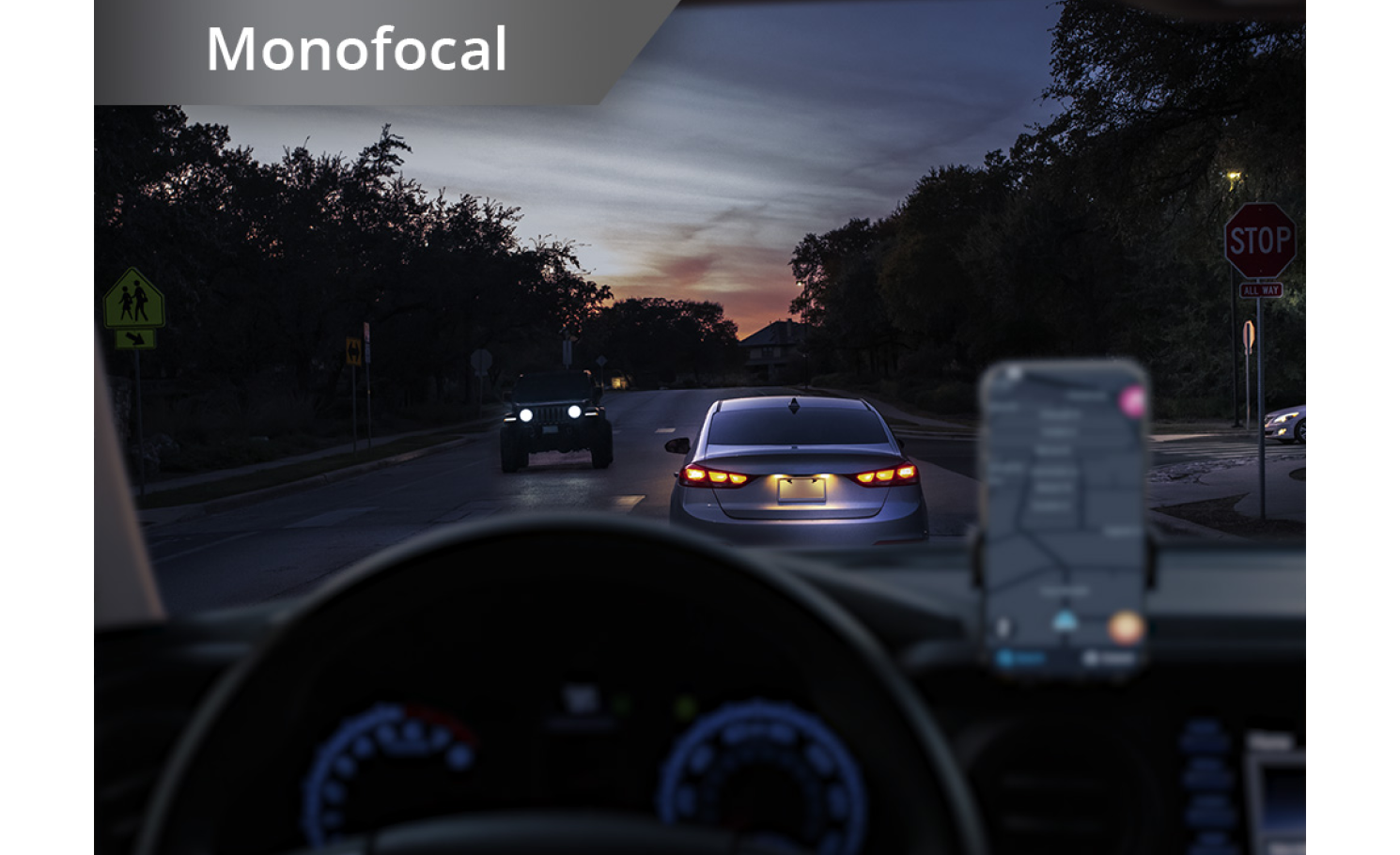 Car on the road in dim lighting with phone set up on the dashboard. White text at the top left corner of this image reads “Monofocal.”