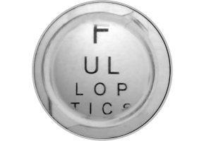 Close-up image of a TECNIS 1-Piece IOL with letters behind it, showing the use of the limited 4.9 mm aspheric optic.