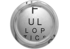 Close-up image of an enVista IOL with letters behind it, showing the use of the limited 4.9 mm aspheric optic.
