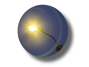 Streetlight at night with visible halo effect, illustrating glare and light scatter around light sources
