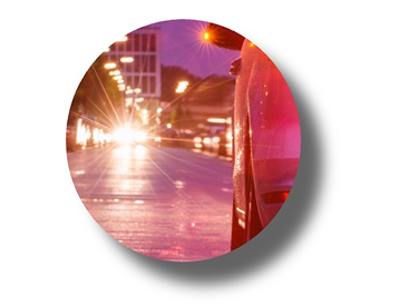 Night driving scene with oncoming headlights and street lighting, illustrating glare and light scatter in low-light conditions