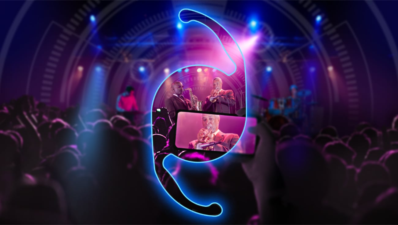 Modern concert scene with a glowing blue see-through IOL silhouette overlay, live musicians performing on stage under neon purple and blue lights, and an audience recording the performance on a smartphone.