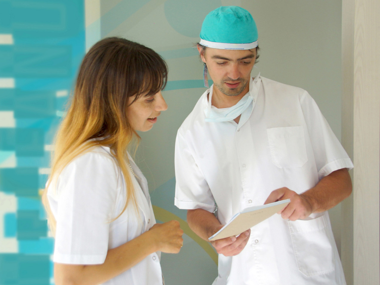 Two doctors looking at a notebook